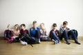 Kids sitting on floor with mobile devices Royalty Free Stock Photo