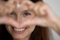 Smiling kind young caucasian attractive woman showing heart.