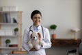 Smiling kind young Indian pediatrician holding toy in hands.