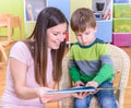 Smiling Kindergarten Teacher Cute Boy Looking a Book Royalty Free Stock Photo