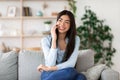 Smiling Korean Girl Talking On Mobile Phone At Home With Her Boyfriend Royalty Free Stock Photo