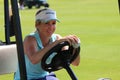 Smiling ladies pro golfer Daniella Montgomery behind steering wheel of golf cart November 2015 in South Africa Royalty Free Stock Photo