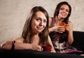 Smiling Ladies on Sofa with Mugs Royalty Free Stock Photo