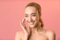 Smiling Lady Applying Facial Cream Looking Aside Posing In Studio Royalty Free Stock Photo