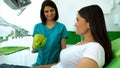 Smiling lady dentist giving green apple to patient, healthcare recommendations