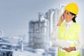 Smiling lady engineer talking on the phone and the factory in th Royalty Free Stock Photo