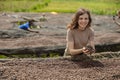 Happy young woman holding dried coffee beans in hands Royalty Free Stock Photo