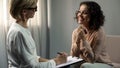 Smiling lady patient thanking her psychologist after depression rehab, therapy