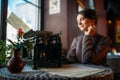 Smiling lady sits by table with ancient typewriter