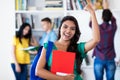 Smiling latin american female student with group of students Royalty Free Stock Photo