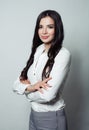 Smiling latin business woman. Crossed arms on gray Royalty Free Stock Photo