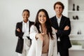 Smiling latin businesswoman HR stretching hand for handshake, greeting to camera, standing with business team indoors Royalty Free Stock Photo