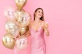 Smiling laughing girl holds glass of champagne and many air balloons. came to party. Celebration Royalty Free Stock Photo
