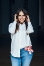 Smiling laughing white Caucasian brunette young beautiful girl woman model with long dark hair and brown eyes in white shirt Royalty Free Stock Photo