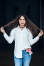 Smiling laughing white Caucasian brunette young beautiful girl woman model with long dark hair and brown eyes in white shirt Royalty Free Stock Photo