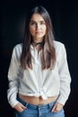 Smiling laughing white Caucasian brunette young beautiful girl woman model with long dark hair and brown eyes in white shirt