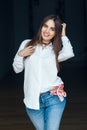 Smiling laughing white Caucasian brunette young beautiful girl woman model with long dark hair and brown eyes in white shirt Royalty Free Stock Photo