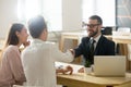 Smiling lawyer or financial advisor handshaking senior couple at Royalty Free Stock Photo