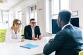 Smiling lawyer, realtor or financial advisor consulting young couple thanking for advice, insurance broker or bank worker discuss Royalty Free Stock Photo