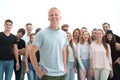 Smiling leader standing in front of a casual group of young people