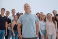 smiling leader standing in front of a casual group of young people