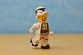 Smiling lego figurine with a stormtrooper helmet riding on roller skates