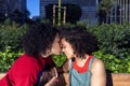 Smiling lesbian couple embracing and relaxing on a park bench Royalty Free Stock Photo