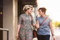 Smiling lesbian couple walking with shopping bags in the city Royalty Free Stock Photo