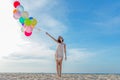 Smiling lifestyle asian woman hand holding balloon on the beach. Relax and Enjoy in summer holiday. Royalty Free Stock Photo