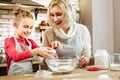Smiling light-haired little child being entertained with cooking