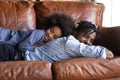 Smiling little African American girl lying on father back Royalty Free Stock Photo