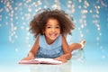 Smiling little african american girl reading book Royalty Free Stock Photo