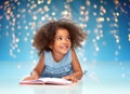 Smiling little african american girl reading book Royalty Free Stock Photo