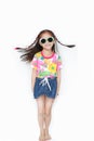 Smiling little Asian child girl wearing a floral pattern summer dress and sunglasses isolated on white background. Summer and Royalty Free Stock Photo