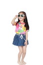 Smiling little Asian child girl wearing a floral pattern summer dress and sunglasses isolated on white background. Summer and Royalty Free Stock Photo