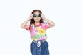 Smiling little Asian child girl wearing a floral pattern summer dress and sunglasses isolated on white background. Summer and Royalty Free Stock Photo