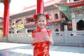 Smiling little Asian girl received a red envelope. Chinese New Year celebration Royalty Free Stock Photo