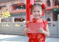 Smiling little Asian girl received a red envelope. Chinese New Year celebration Royalty Free Stock Photo