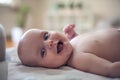 Smiling little baby boy lying on bed and looking at camera. Royalty Free Stock Photo