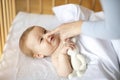 Smiling little baby laying in wooden bed Royalty Free Stock Photo