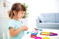 Smiling little beautiful girl sculpt new house of plasticine. Children creativity. Happy childhood. Housewarming dreams