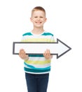 Smiling little boy with blank arrow pointing right Royalty Free Stock Photo