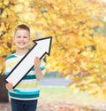 Smiling little boy with blank arrow pointing right Royalty Free Stock Photo