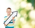 Smiling little boy with blank arrow pointing right Royalty Free Stock Photo