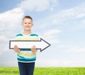 Smiling little boy with blank arrow pointing right Royalty Free Stock Photo