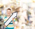 Smiling little boy with blank arrow pointing right Royalty Free Stock Photo