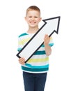 Smiling little boy with blank arrow pointing up Royalty Free Stock Photo