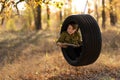 Smiling little boy with book in wheel swing outdoors Royalty Free Stock Photo