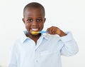 Smiling little boy brushing his teeth