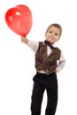 Smiling little boy gives a red balloon Royalty Free Stock Photo